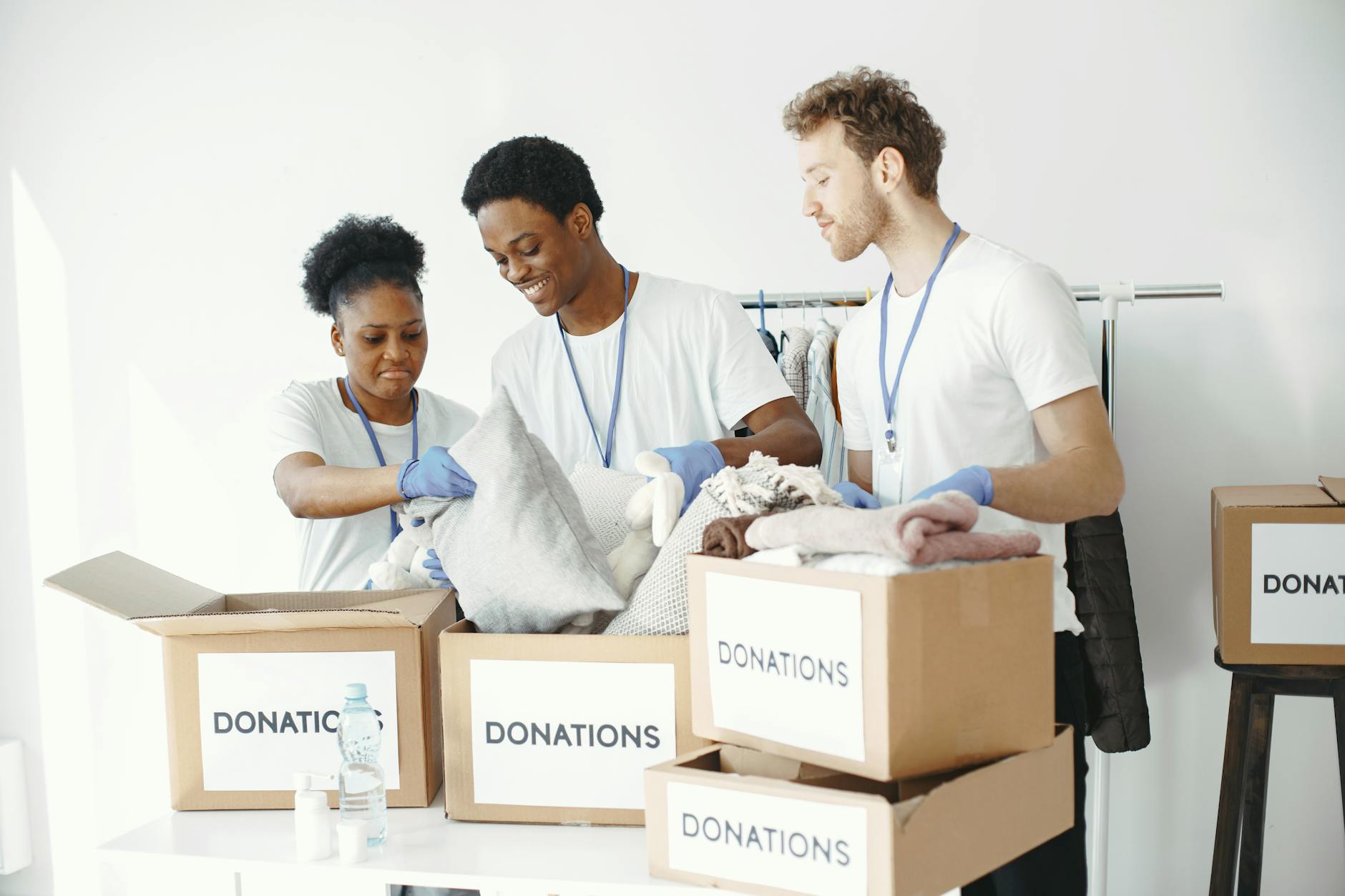 Volunteers organizing donation boxes for social assistance program